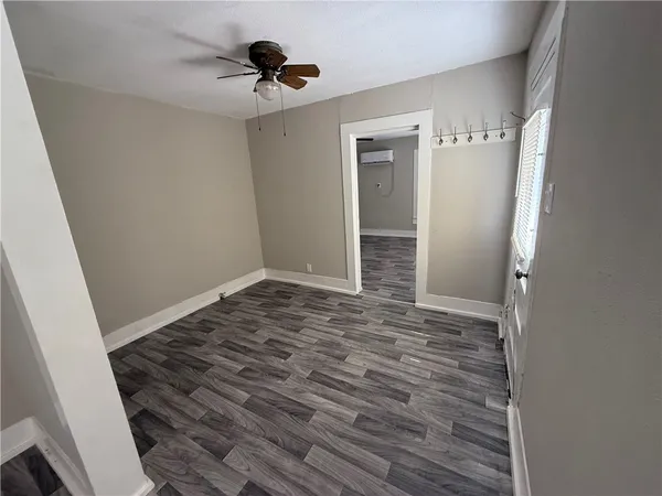 a view of an empty room and wooden floor