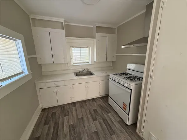 a kitchen with granite countertop white cabinets and white appliances