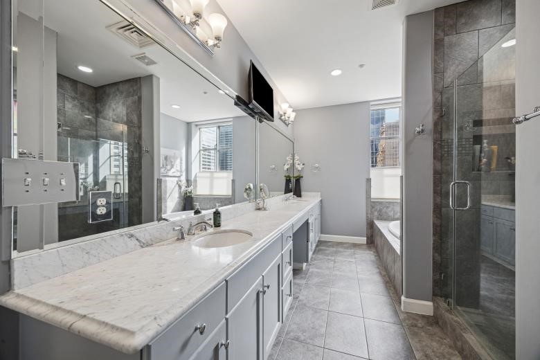 914 Main Street, Unit 1204 Houston, TX 77002 - Photo 10 of 34 Completely updated primary bathrooms with walk-in shower and jetted tub.