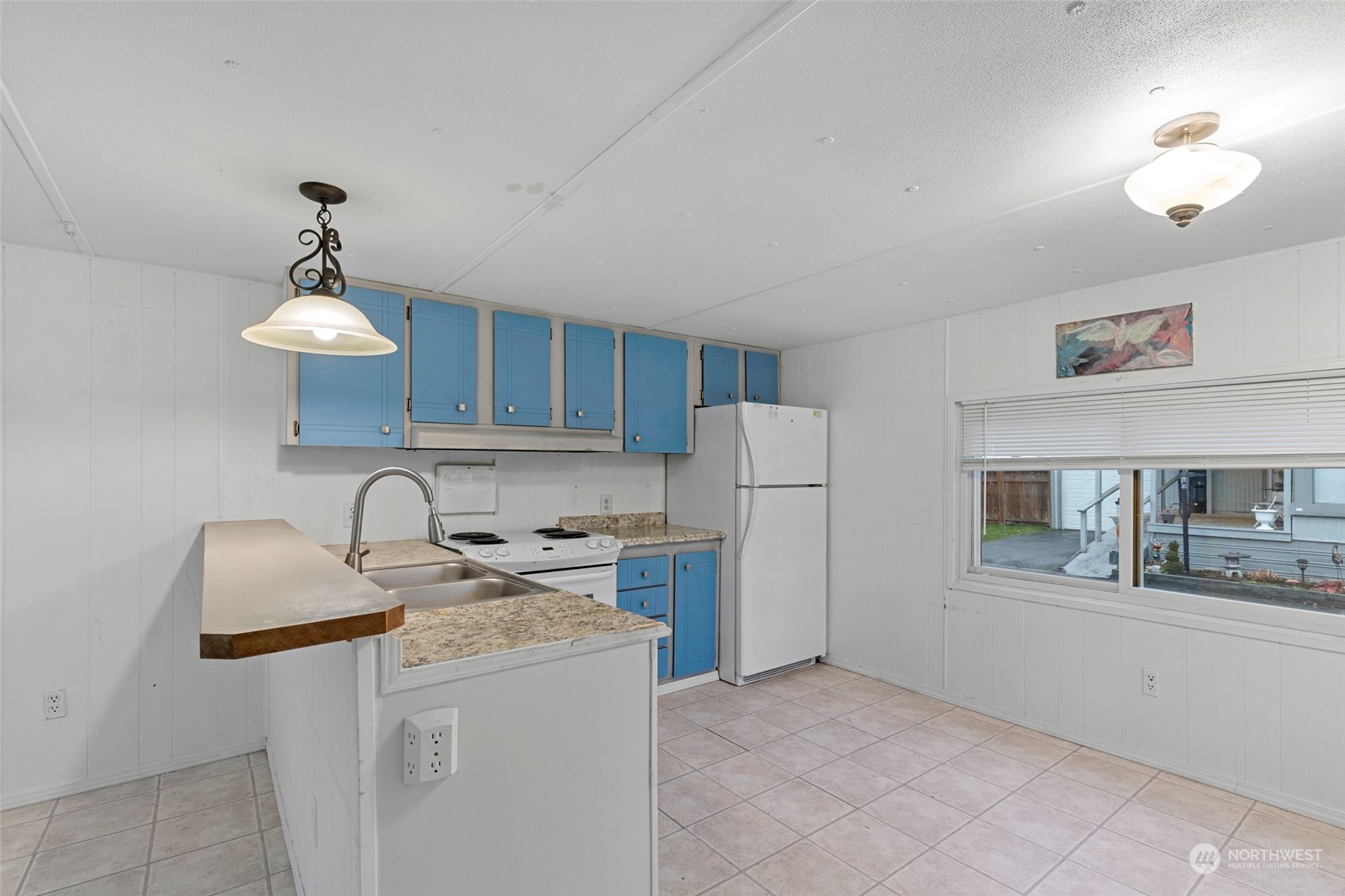 2522 Old Highway 99 South Road, Unit 23 Mount Vernon, WA 98273 - Photo 9 of 22 a kitchen with stainless steel appliances granite countertop a stove refrigerator a sink dishwasher with a dining table and chairs