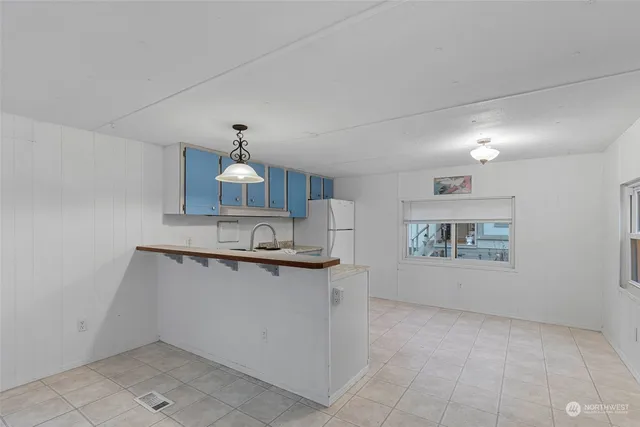 a kitchen with stainless steel appliances a sink stove and cabinets