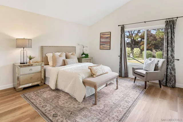 a bedroom with a bed and a large window