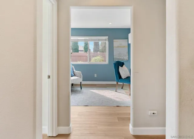 a view of a room with wooden floor and windows