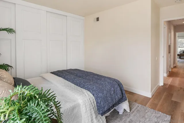 a bedroom with a bed and a dresser