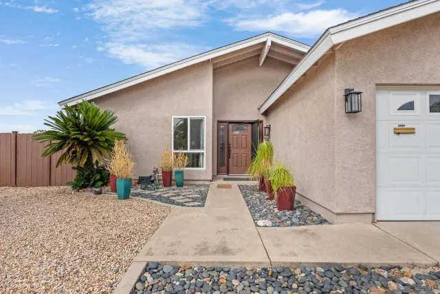 a view of a white house with a patio