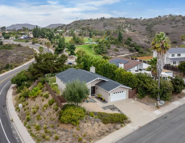 an aerial view of residential houses with outdoor space