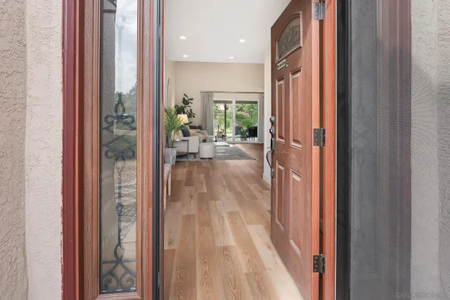 a view of a hallway with a livingroom and furniture