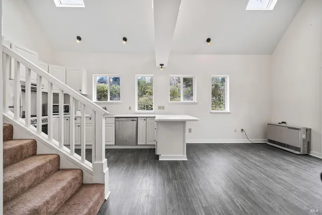 a view of room with stairs and wooden floor