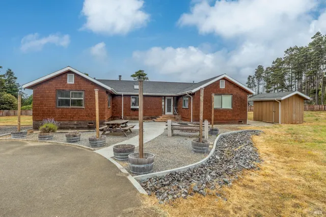 a front view of a house with garden