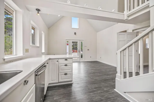 a kitchen with granite countertop a stove and a sink