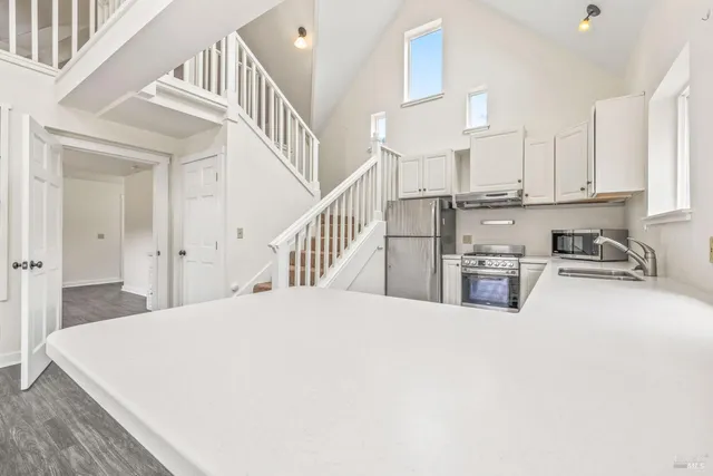 a view of kitchen with cabinets and window
