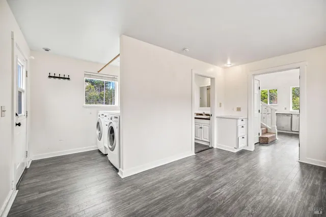 a view of a kitchen with wooden floor and a refrigerator