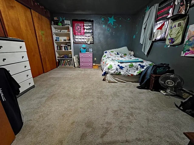 a bedroom with furniture and a baby crib