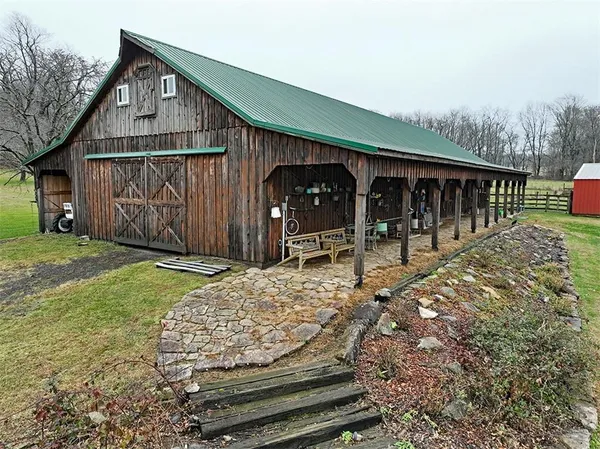 a wooden bench sitting in front of a house