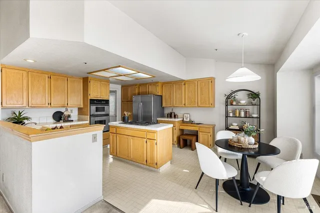 a kitchen that has a cabinets counter space dining table and a sink