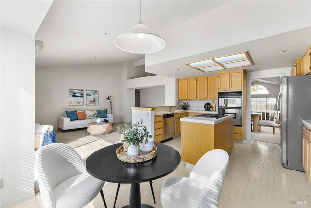 a living room with furniture kitchen and a table