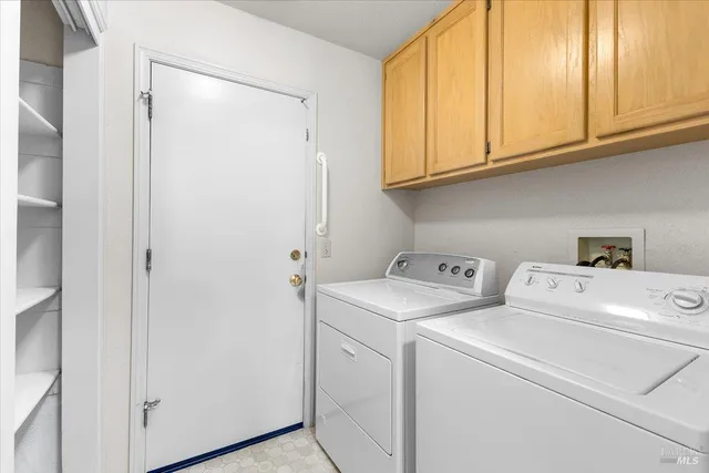 a view of storage and utility room with washer and dryer