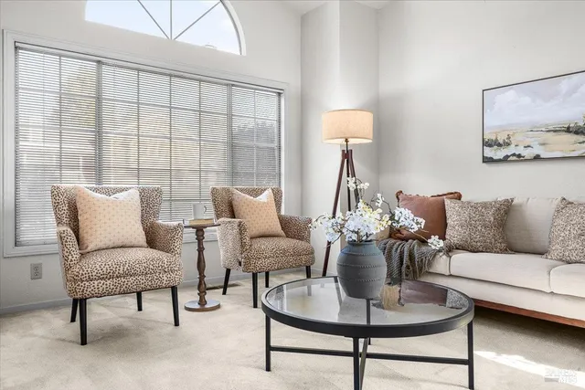 a living room with furniture and a potted plant