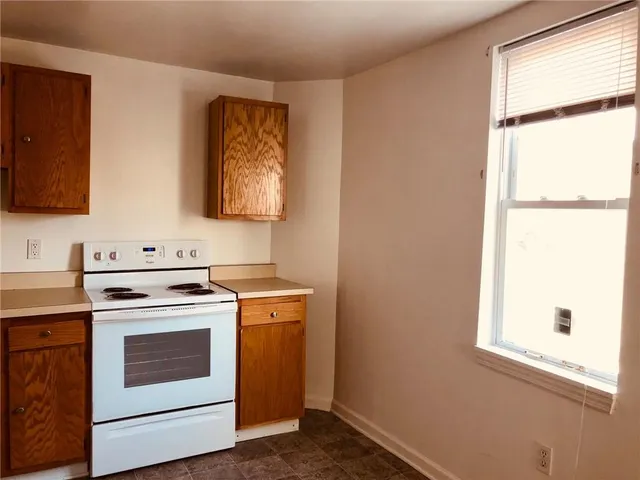 a view of a refrigerator in kitchen and wooden floor