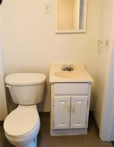 a white toilet sitting next to a bathroom sink