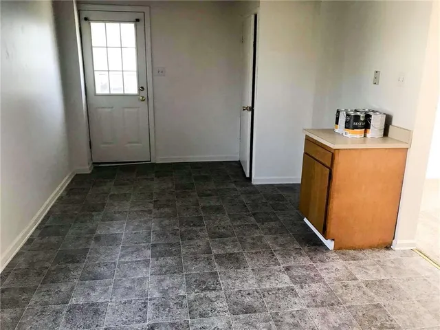 an empty room with closet and mirror