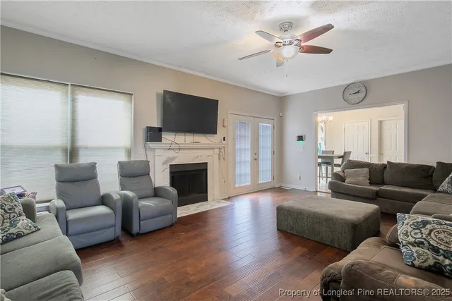 a living room with furniture a fireplace and a flat screen tv