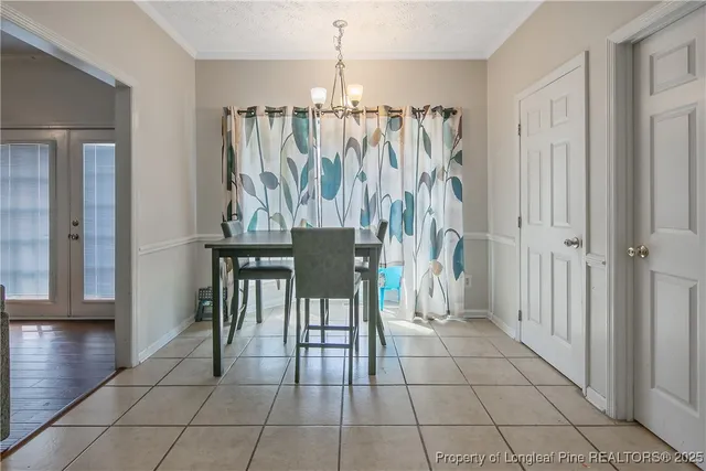 a view of a livingroom with furniture and chandelier wooden floor a chandelier