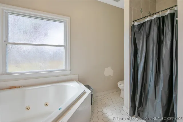 a bathroom with a tub and a shower
