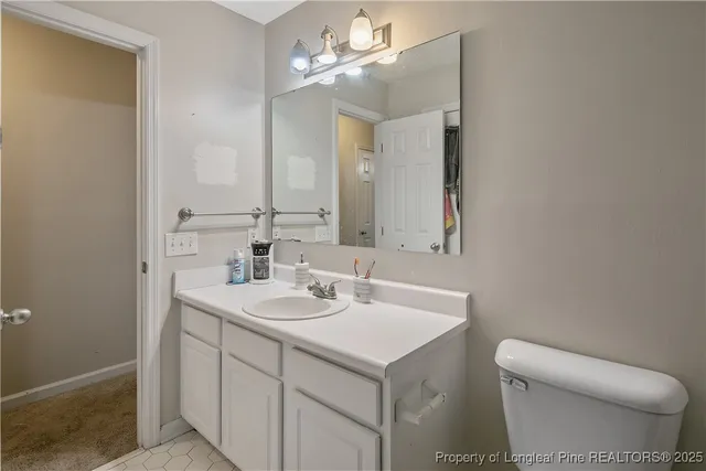 a bathroom with a sink a toilet and a mirror