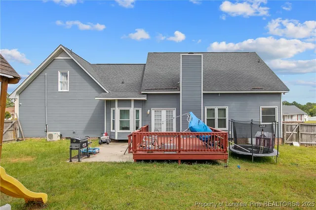 a backyard of a house with barbeque oven table and chairs