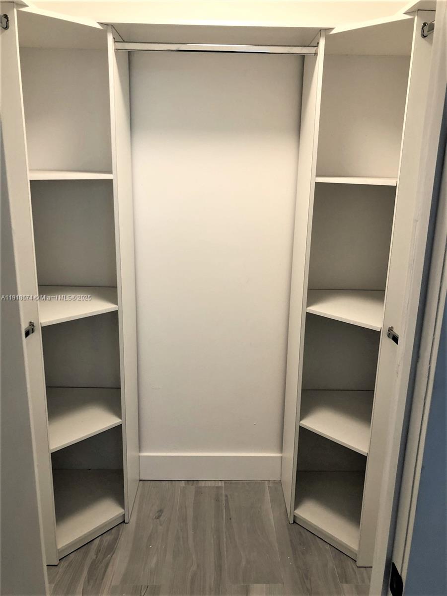 5701 Collins Avenue, Unit 808 Miami Beach, FL 33140 - Photo 12 of 40 a view of walk in closet with empty racks