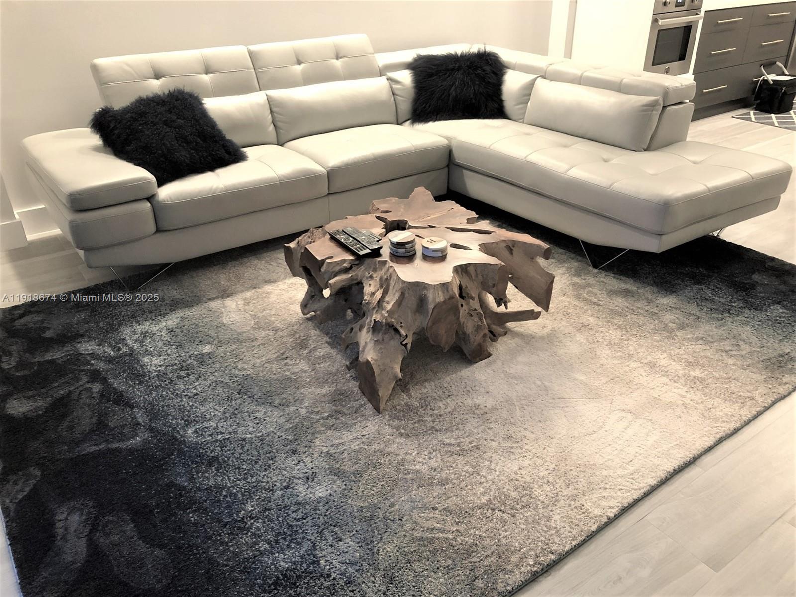 5701 Collins Avenue, Unit 808 Miami Beach, FL 33140 - Photo 13 of 40 a living room with furniture and a rug