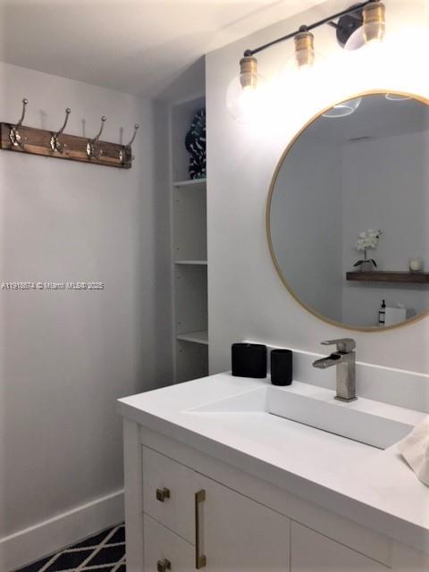 5701 Collins Avenue, Unit 808 Miami Beach, FL 33140 - Photo 14 of 40 a bathroom with a sink and mirror