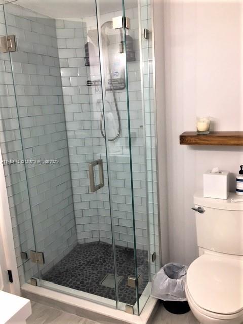 5701 Collins Avenue, Unit 808 Miami Beach, FL 33140 - Photo 15 of 40 a bathroom with a shower and toilet