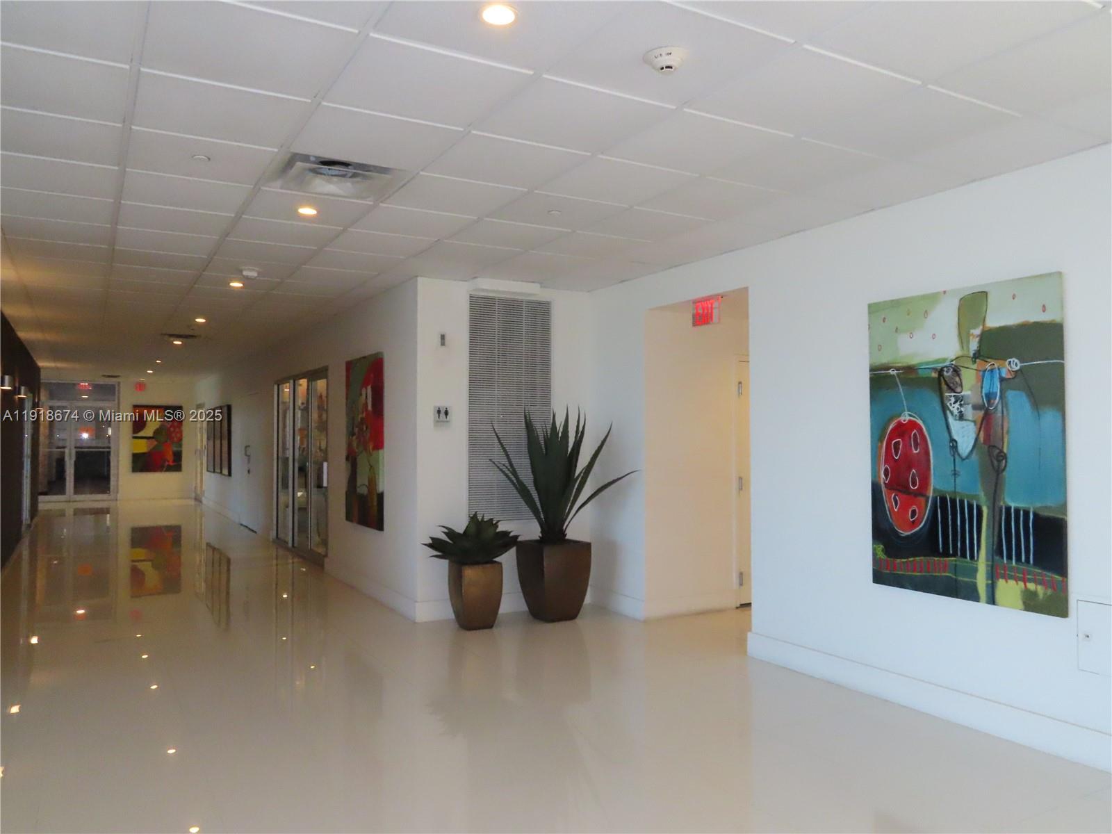 5701 Collins Avenue, Unit 808 Miami Beach, FL 33140 - Photo 29 of 40 a view of a hallway with a couch and a potted plant