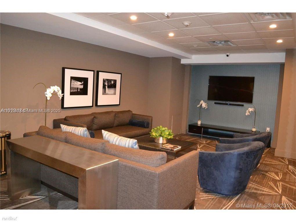 5701 Collins Avenue, Unit 808 Miami Beach, FL 33140 - Photo 38 of 40 a living room with furniture and a flat screen tv