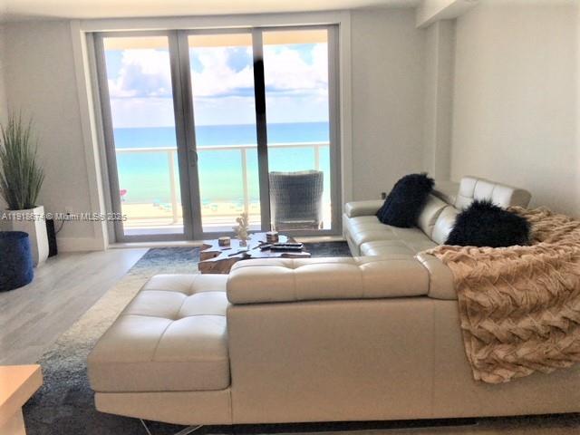 5701 Collins Avenue, Unit 808 Miami Beach, FL 33140 - Photo 6 of 40 a living room with furniture and a large window