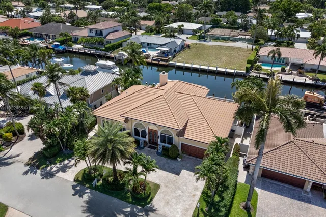 an aerial view of a house with garden space and lake view