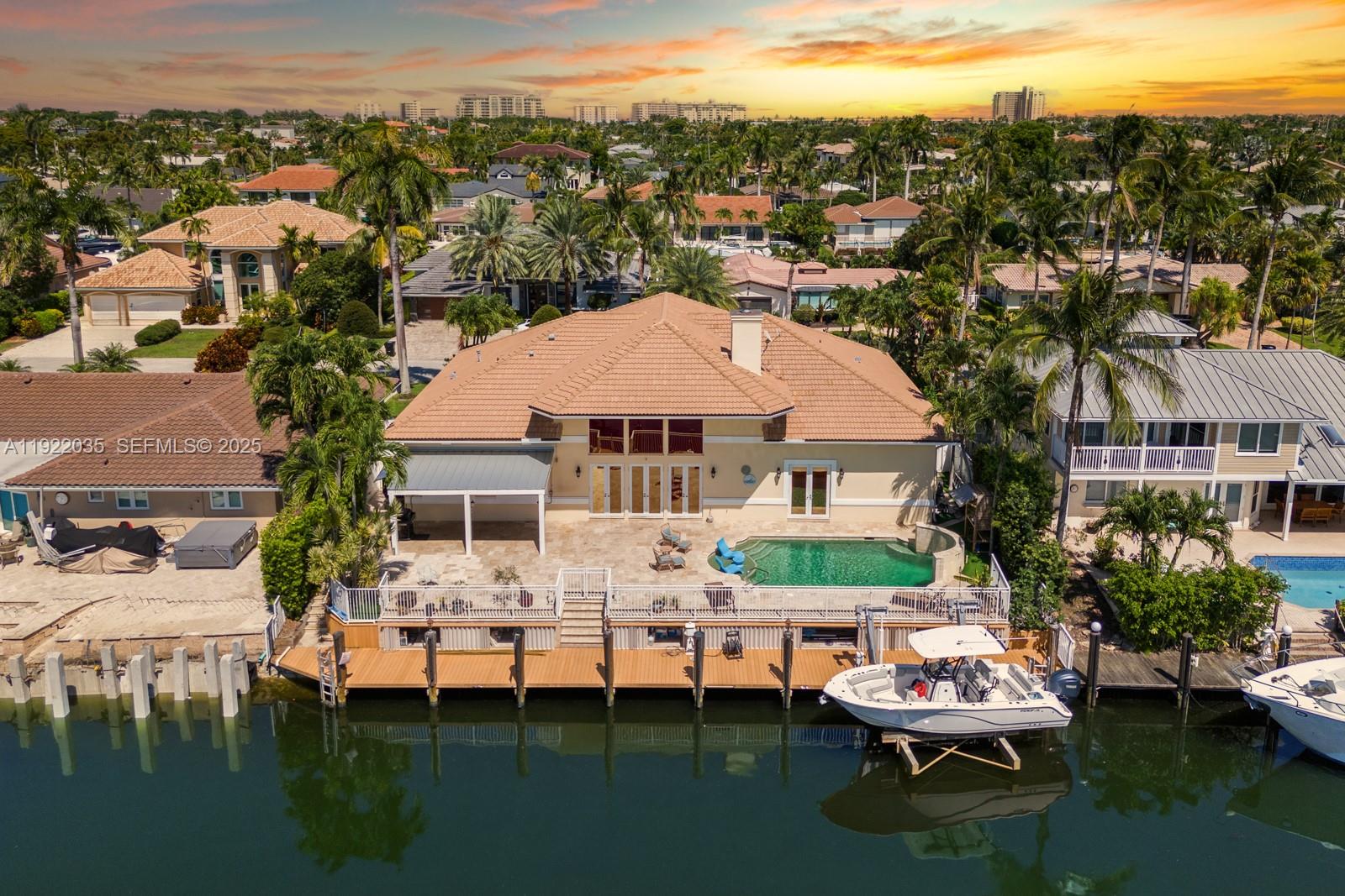 4241 Northeast 23rd Terrace Lighthouse Point, FL 33064 - Photo 11 of 26 a view of a lake with a table and chairs