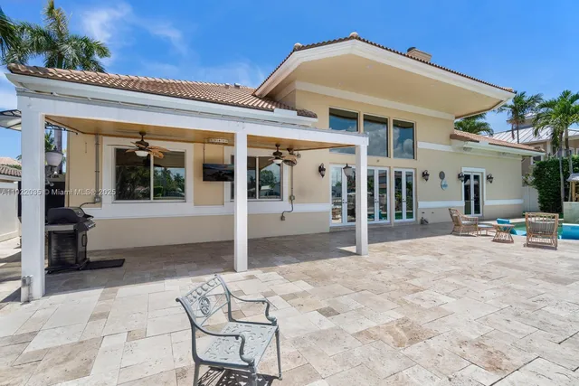 a view of a house with backyard porch and sitting area