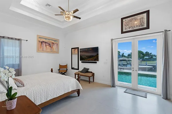 a bedroom with a bed and a flat screen tv