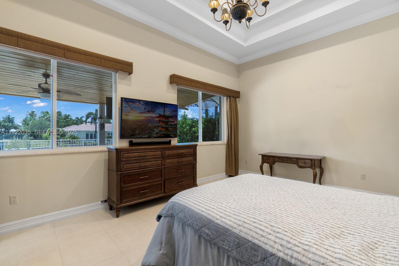 4241 Northeast 23rd Terrace Lighthouse Point, FL 33064 - Photo 25 of 26 a bedroom with a bed and a flat screen tv