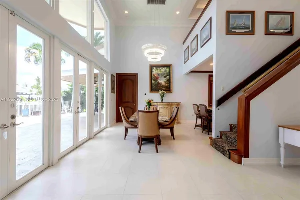 a dining room with furniture and a large window