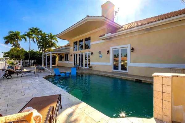 a view of a house with backyard porch and sitting area