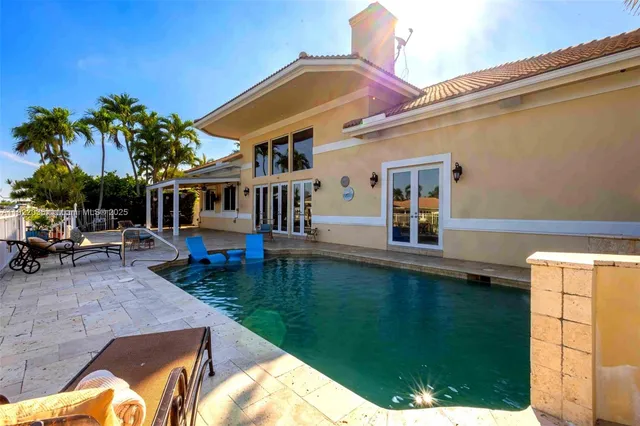 a view of a house with backyard porch and sitting area