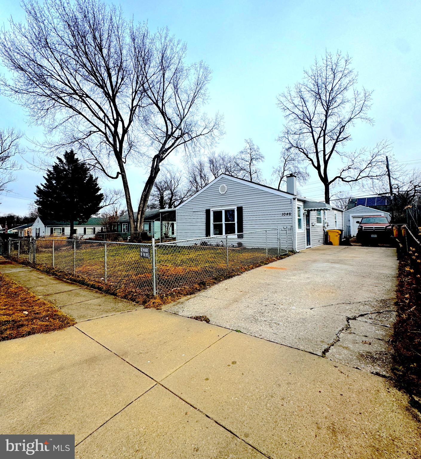 a view of a white house with a yard