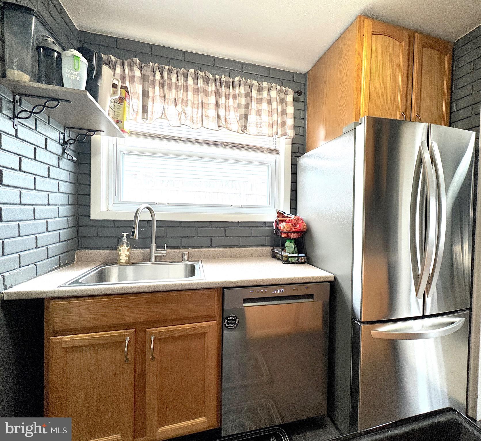 1046 Thomas Road Glen Burnie, MD 21060 - Photo 13 of 30 a kitchen with appliances a sink and a counter top space