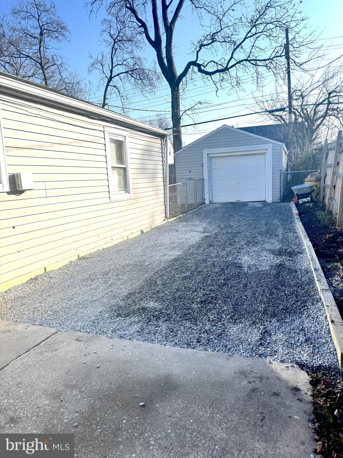 1046 Thomas Road Glen Burnie, MD 21060 - Photo 30 of 30 a view of a house with a yard and garage