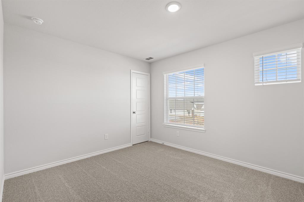 7904 Bald Cypress Road Fort Worth, TX 76123 - Photo 14 of 23 an empty room with windows