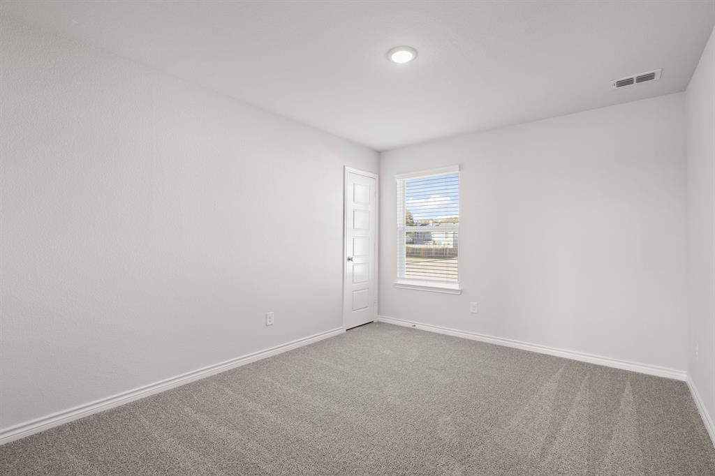 7904 Bald Cypress Road Fort Worth, TX 76123 - Photo 18 of 23 a view of an empty room with a window